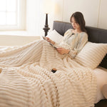 Reading on the sofa wrapped in the Cream White CloudHug blanket