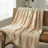 CloudHug Bubble Plush Blanket in Cream White draped over a wooden bench