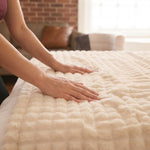 Hand pressing into the cloud-soft bubble texture of the CloudHug blanket